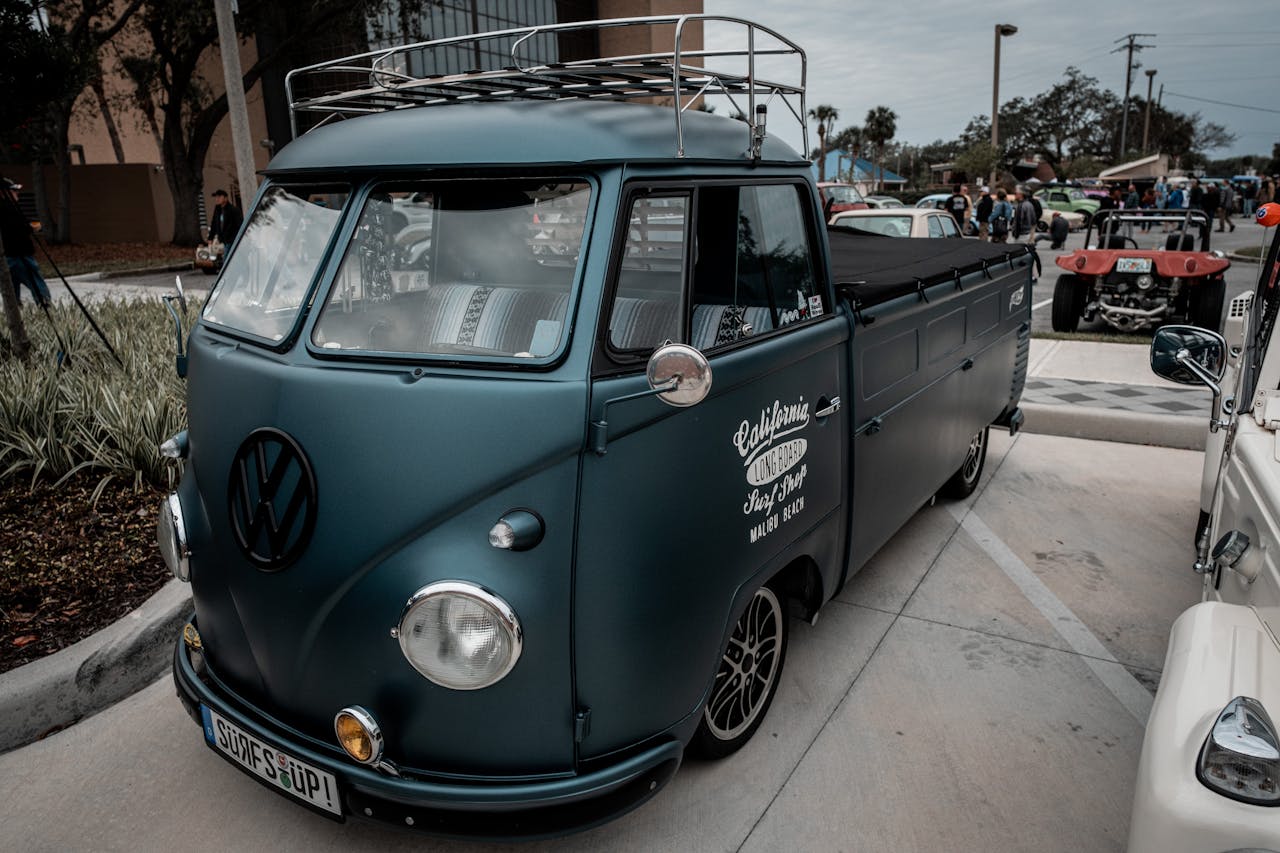 Classic Volkswagen pickup truck displayed at a car show, showcasing its vintage style.